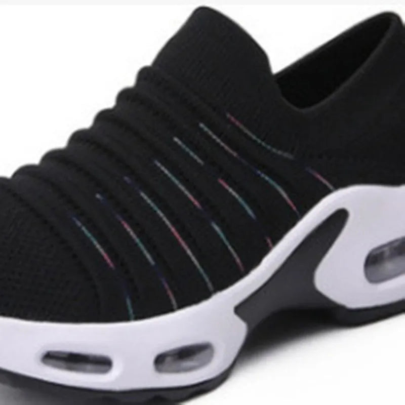 Stretch knitted mesh sock shoe for women in light grey colour with round toe and low heel.
