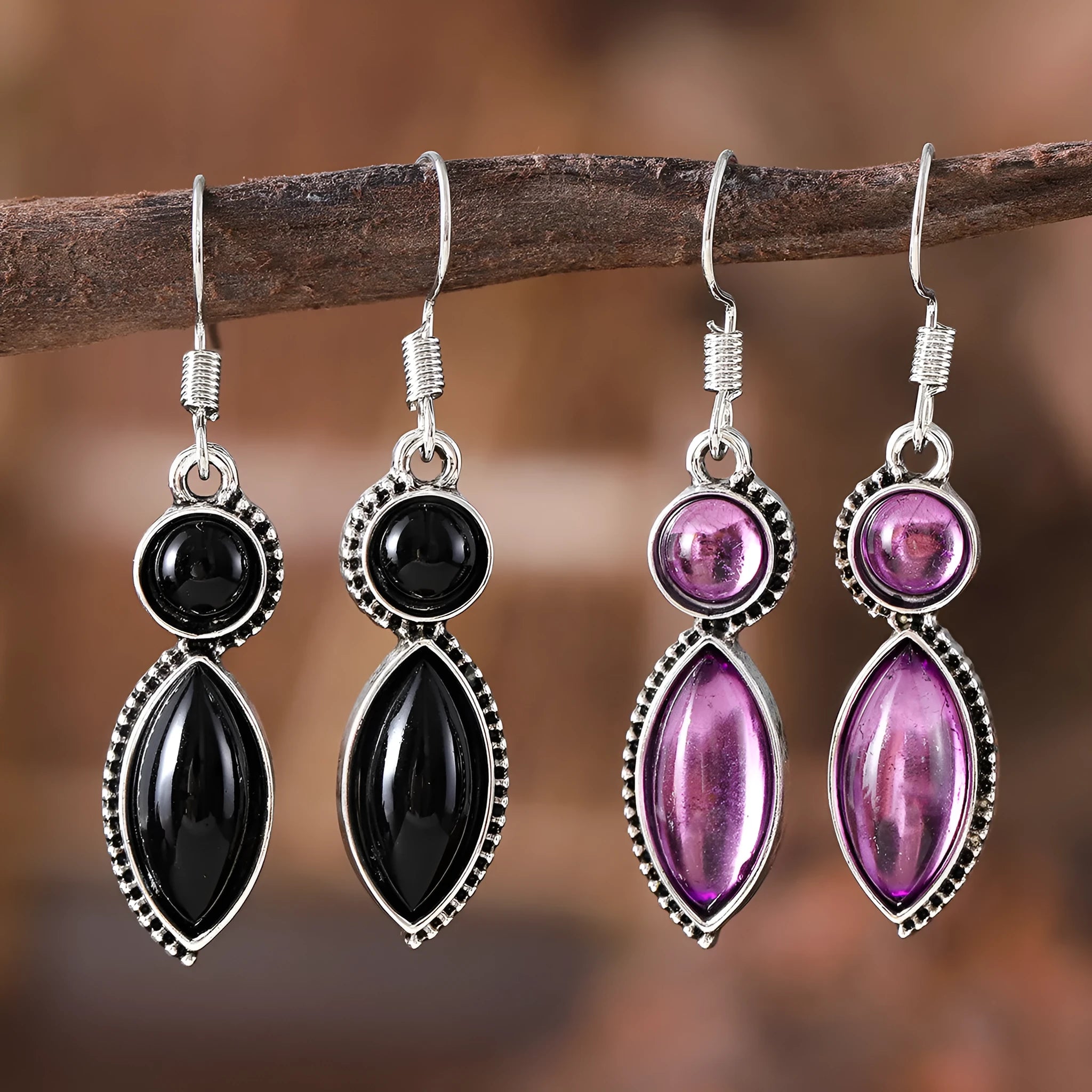 A pair of vintage geometric pendant earrings in black and purple with a Bohemian style.