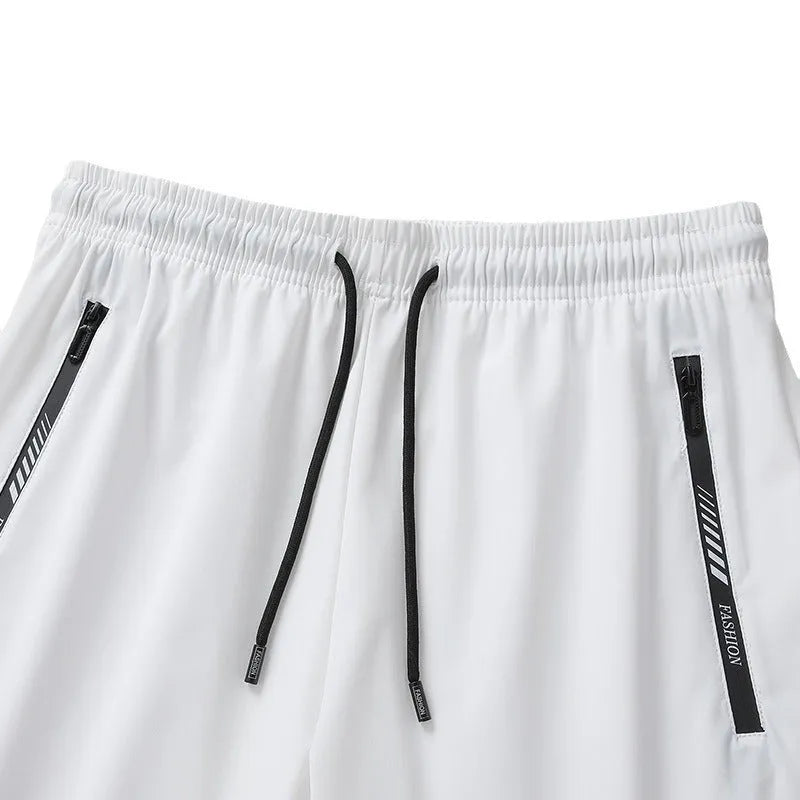 Men's black loose-fit nylon sports shorts on a hanger