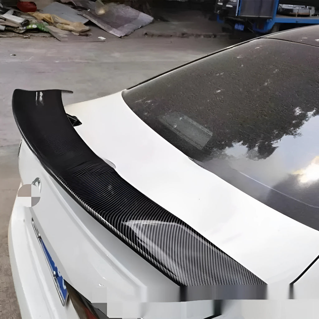 Universal punch-free car spoiler tail wing in ABS plastic on a vehicle.