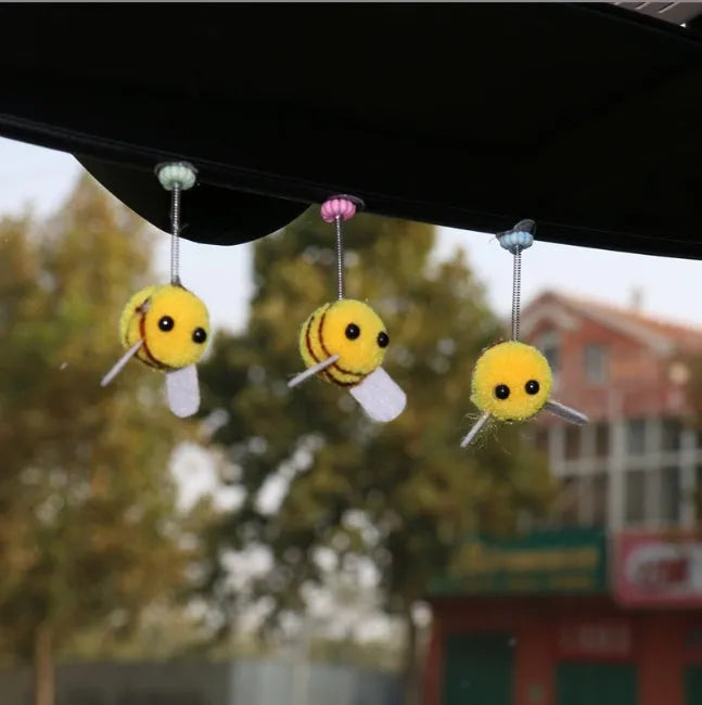 Swing Spring Bee soft fur ball car decoration with cartoon bee shape on adhesive backing.