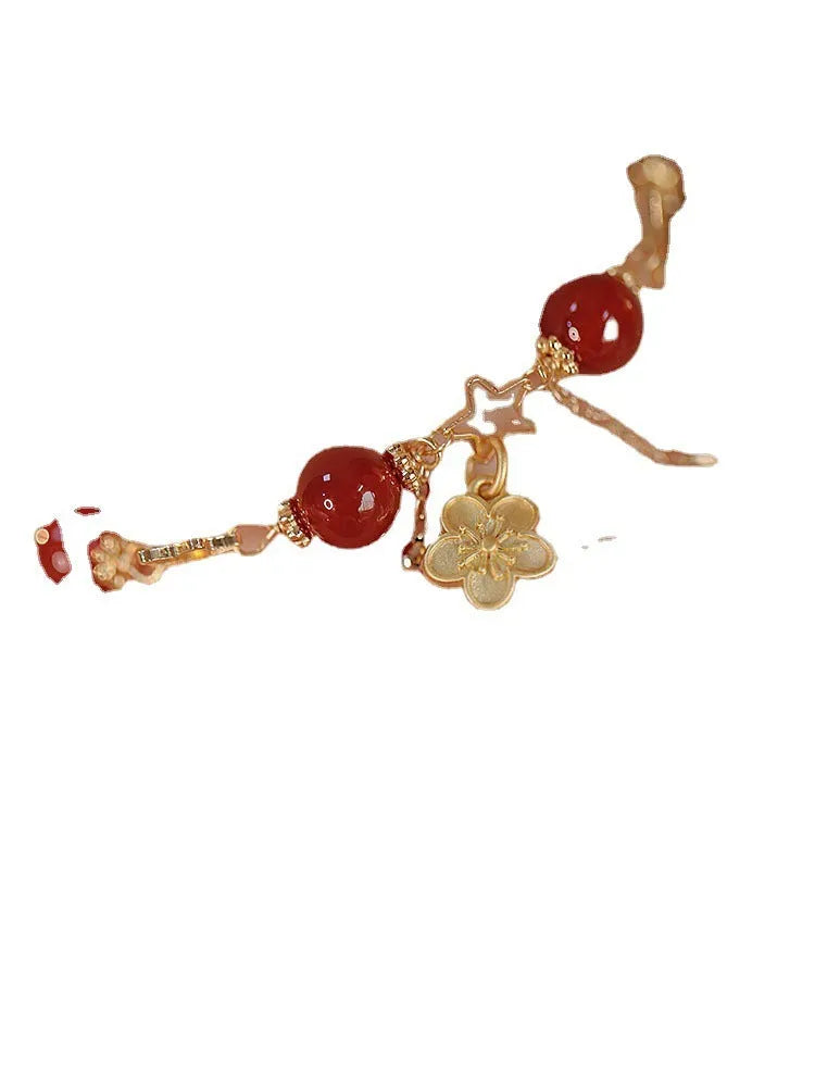 Red agate double layer bracelet with floral and peach blossom detailing on woman's wrist