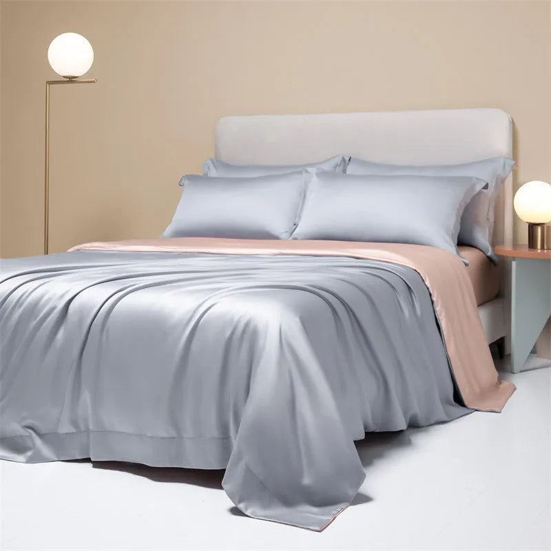 200 thread count Lenzing Tencel quilt cover and sheet set in Aurora Blue, laid on a bed.