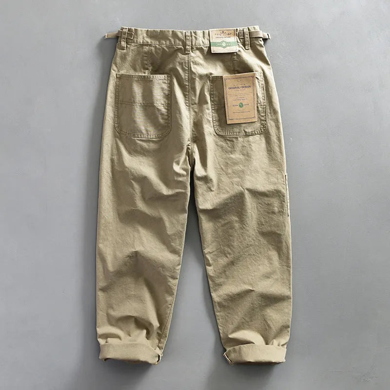 Men's straight-leg cotton casual trousers in apricot colour on a hanger
