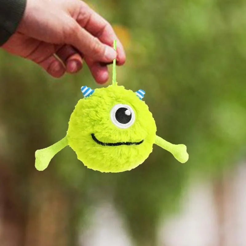 Green plush and TPR sound-activated dog teething toy ball, 12cm diameter.