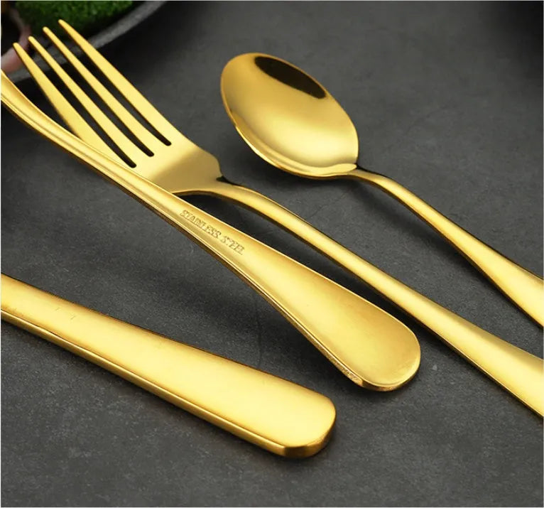 24 piece stainless steel tableware set showing knives, forks, and spoons in multiple colour finishes