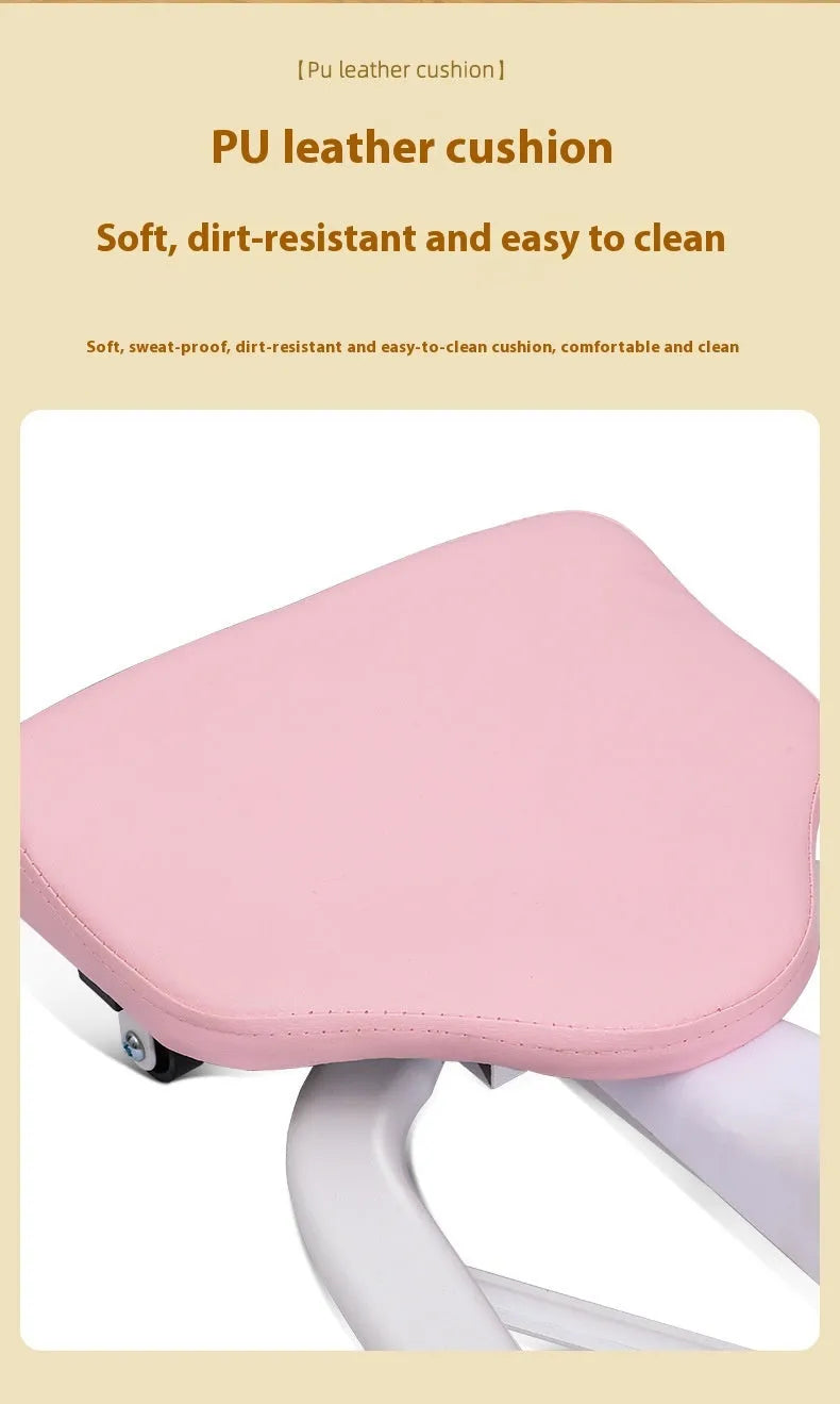 Pink and blue adjustable leg stretching trainer with steel frame and foam padding on a studio floor.