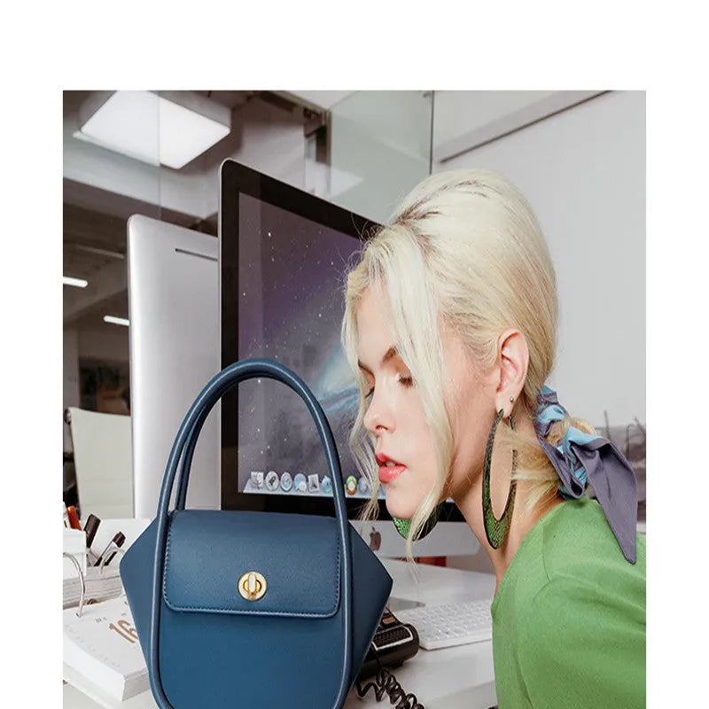 A wing-shaped cow leather women's tote bag with a cross-body strap and latch closure in a choice of colours.