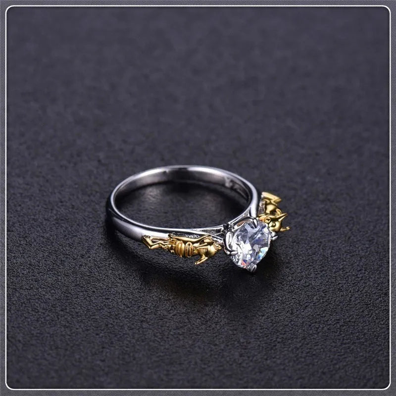 Black gold crystal crown ring on a finger, showing copper metal and decorative stones.