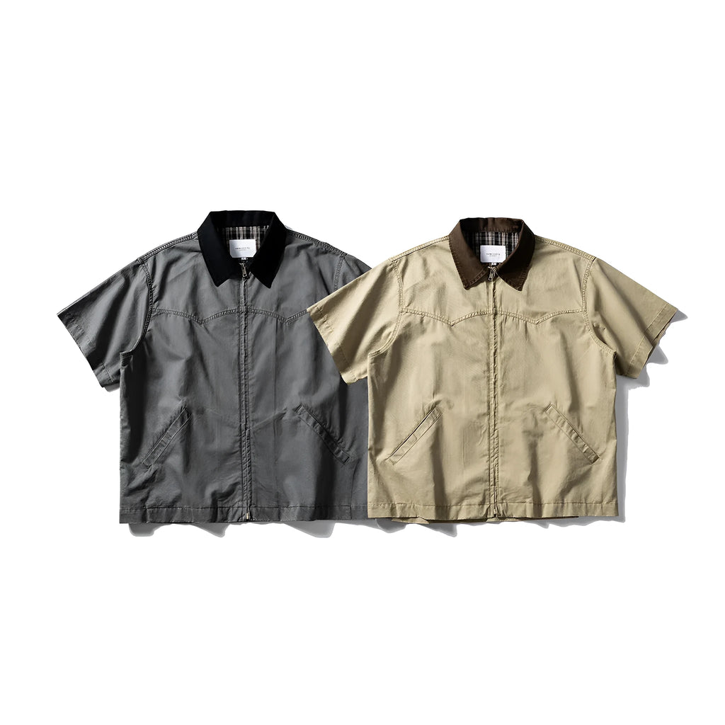 A loose grey or khaki cotton short-sleeved overall shirt, shown as an oversized cardigan style.