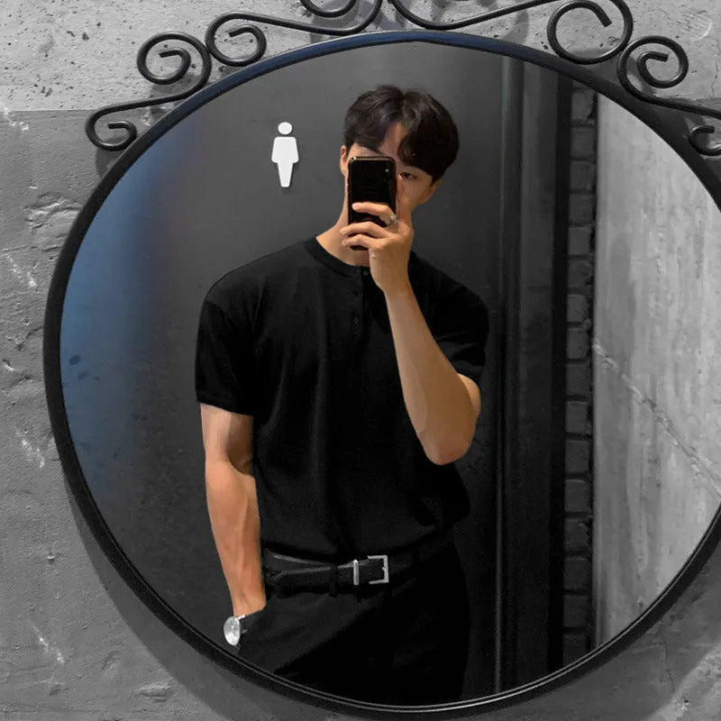 Man wearing a slim-fit black short-sleeved ice silk knitted pullover shirt.