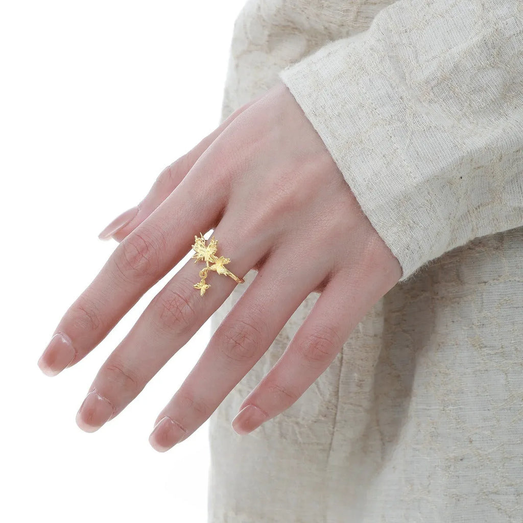 Silver butterfly ring with adjustable opening in white gold or gold finish.