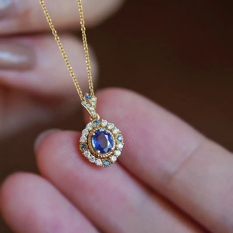 Golden women's necklace with a sparkling zircon inlaid gemstone pendant on an adjustable box chain.