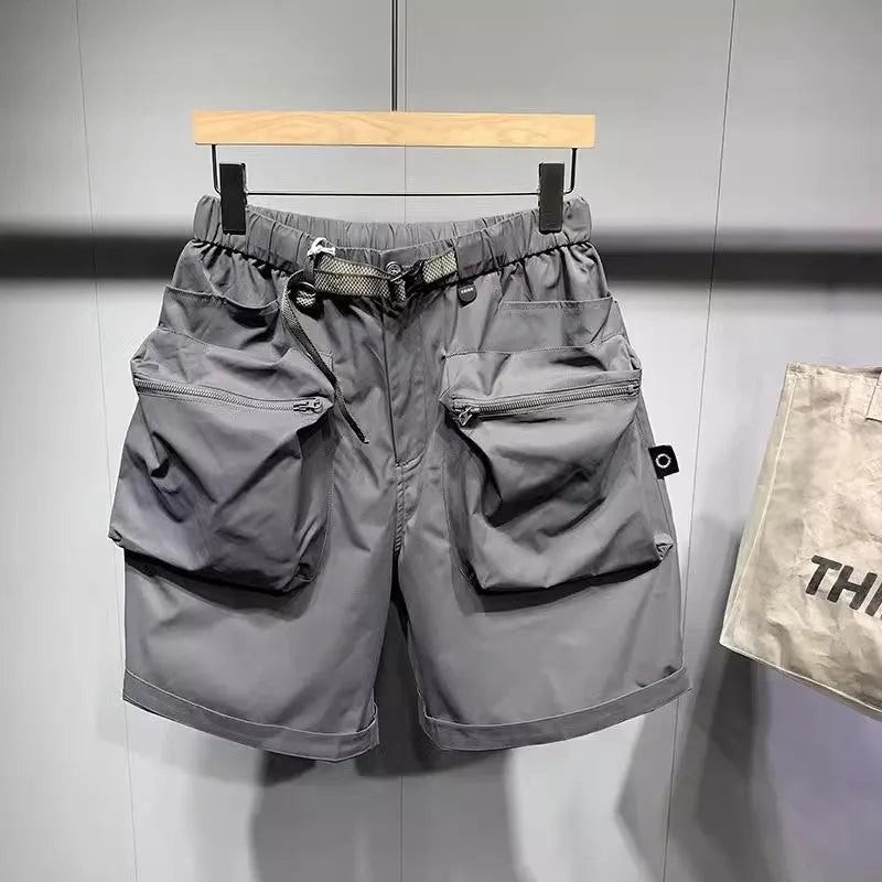 Men's large size loose fitting black shorts with pockets and straight leg hem.