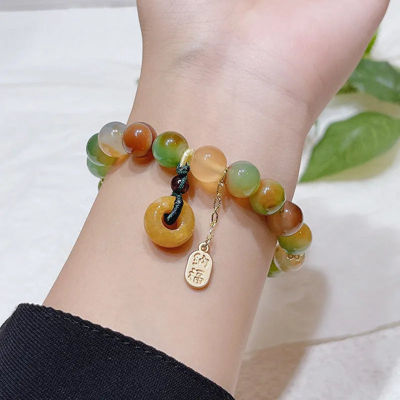 Yellow peacock agate women's bracelet with peace buckle clasp and old mine topaz accents
