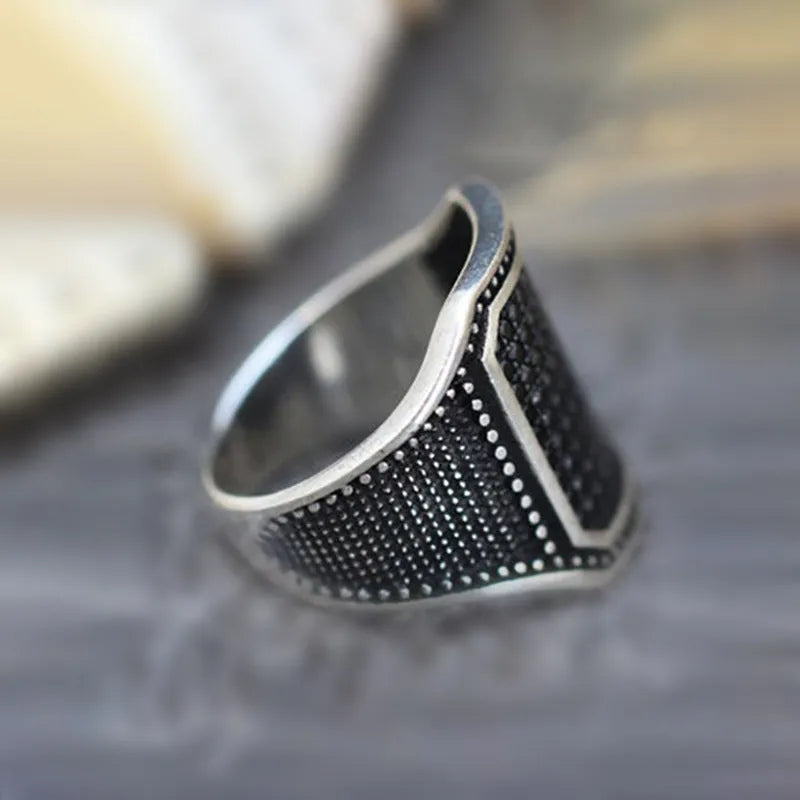 Black alloy ring with copper inlay and zircon detailing on a finger, showing ring sizes 7 to 13.