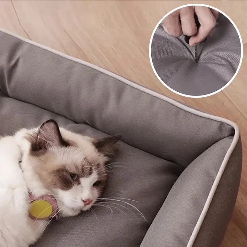 Gray luxury dog sofa bed with raised edges on a wooden floor, showing waterproof Oxford cloth and plush cushion.