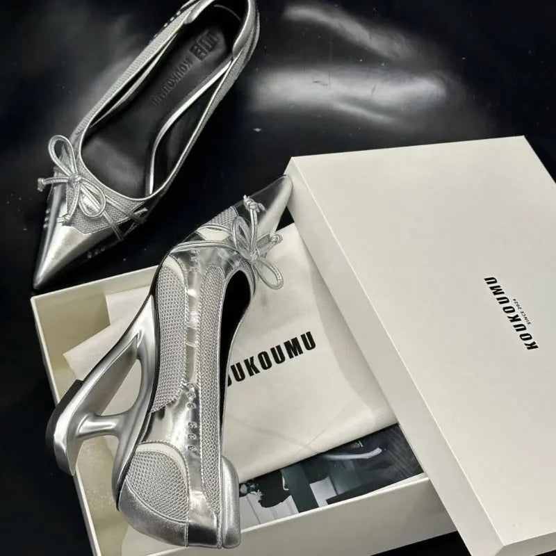 Black women's pointed toe Mary Jane high heels with a distinctive shaped floating heel on a white background.