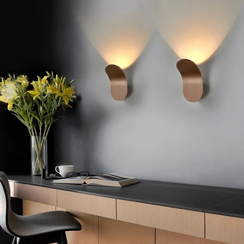 Modern brushed metal wall lamp in gold finish with contemporary design for accent lighting