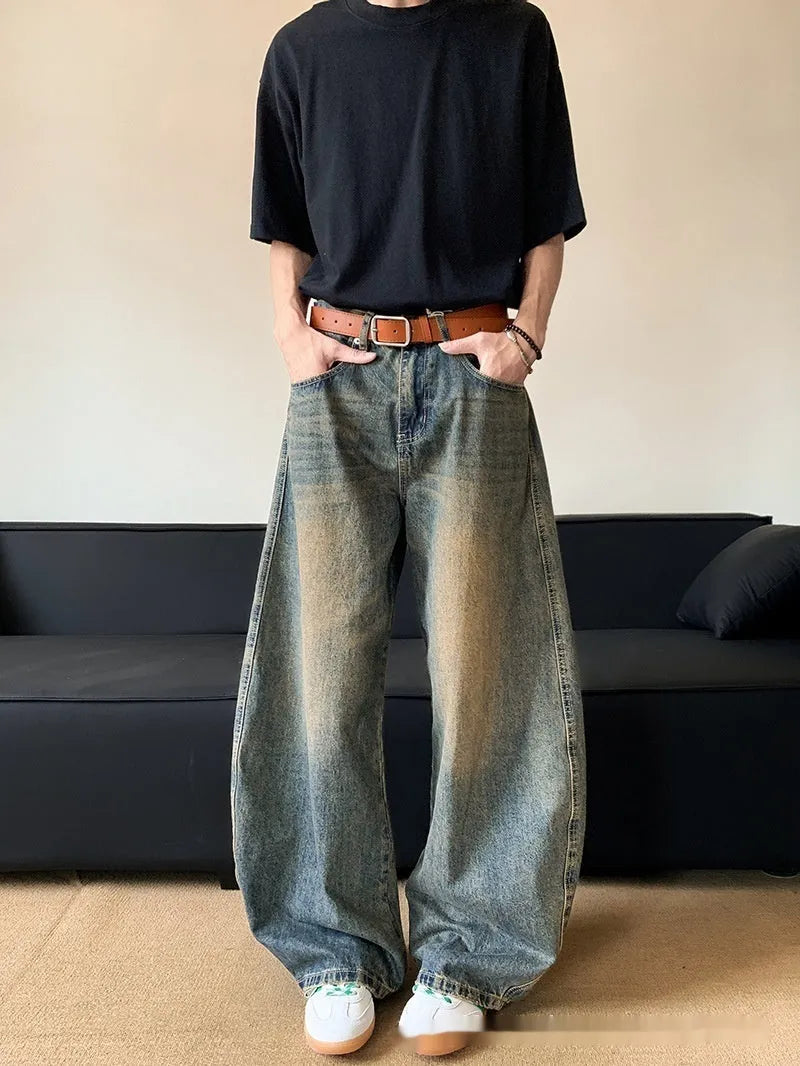Man wearing retro blue distressed wide-leg denim jeans with machete detailing