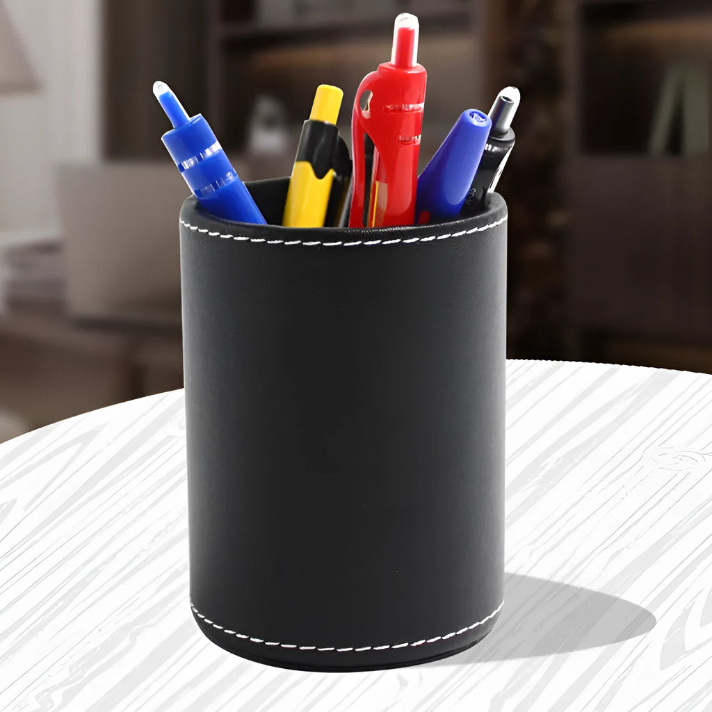 Small round black leather pen holder on a desk