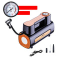 Black portable wireless tire inflator with digital display and USB charging cable on a grey background.