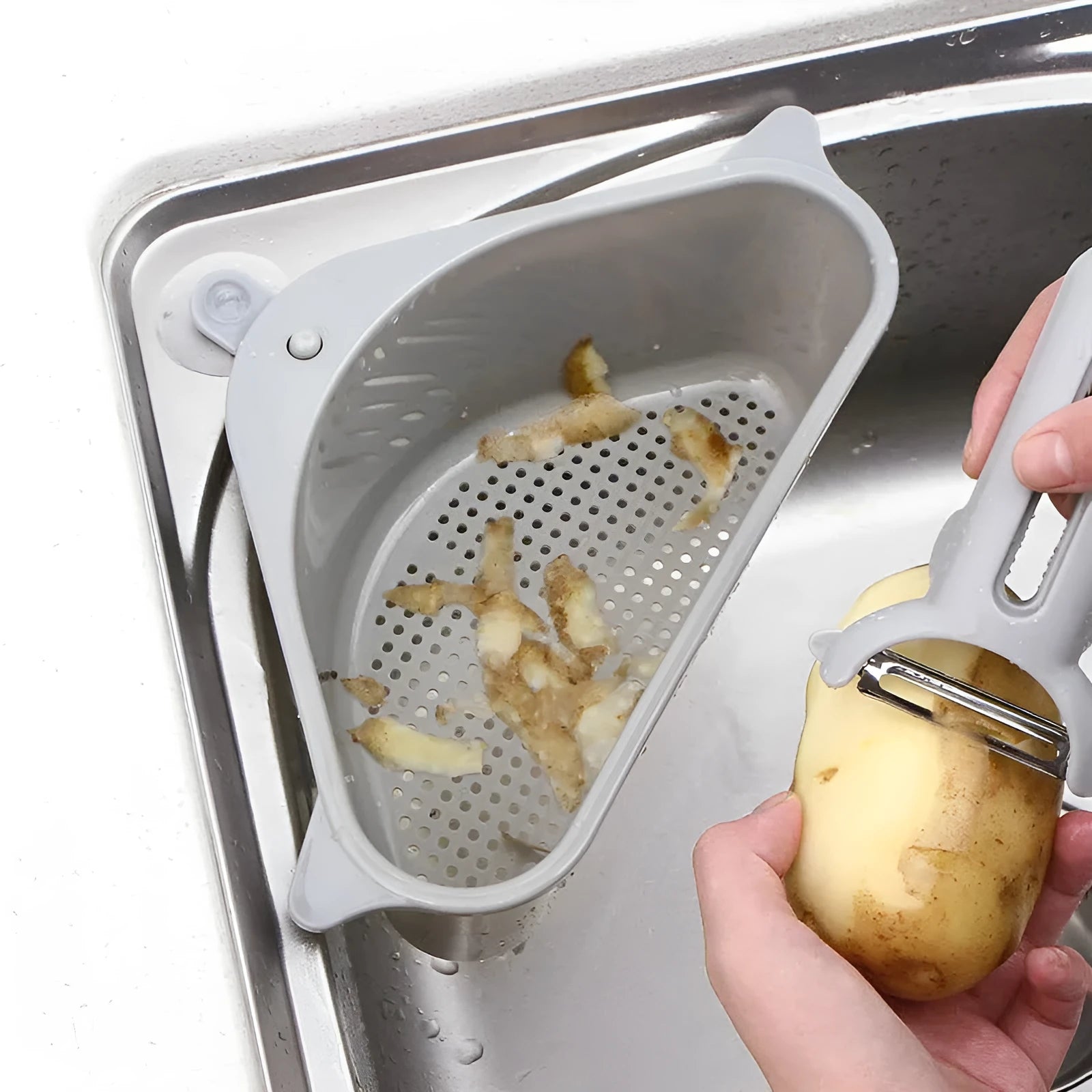Beige and blue plastic triangle sink storage rack with suction cups holding a sponge