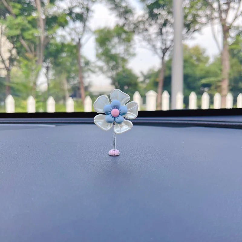 Small plastic colourful swing car decoration shown in multiple colour options.