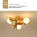Wooden style modern Nordic ceiling light with three neutral light heads.