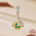 925 silver rotating card pendant with four-leaf clover pattern and wing element on white background