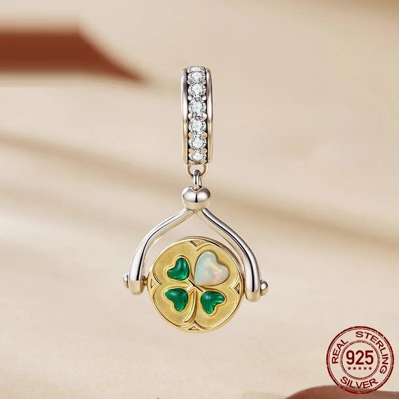 925 silver rotating card pendant with four-leaf clover pattern and wing element on white background