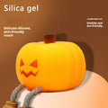 Soft silicone pumpkin-shaped night light with warm yellow glow