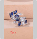 Adjustable open-ended leaf-shaped ring with zirconia stones on a copper band.