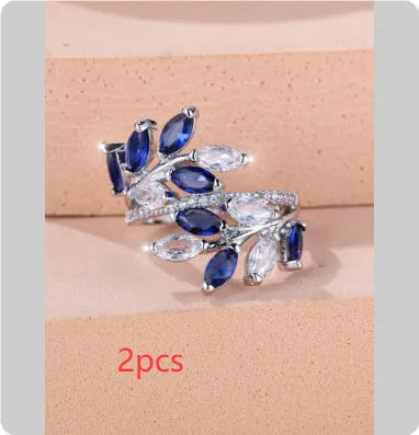 Adjustable open-ended leaf-shaped ring with zirconia stones on a copper band.