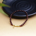 Natural garnet stone set in a 6mm wide bamboo joint bracelet with copper or silver metal finish.