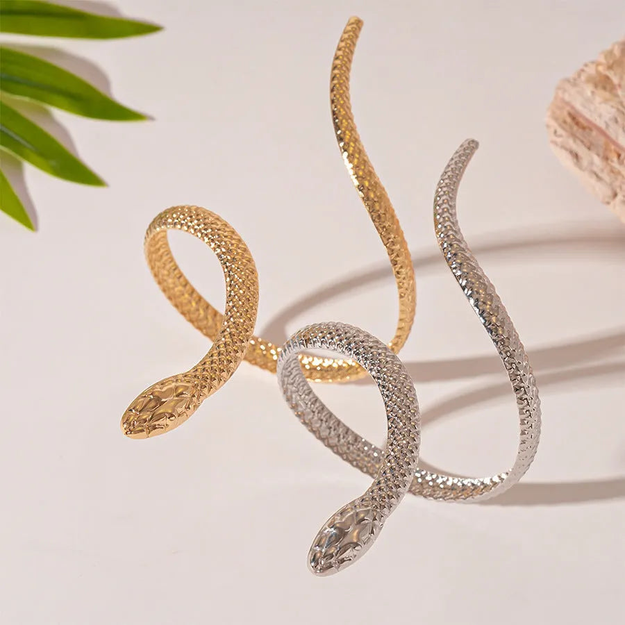 Gold and silver snake-inspired ring and bracelet set with twisted winding design