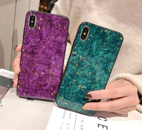 Silicone phone case with gold foil epoxy decoration in a purple solid colour, shown fitted on a smartphone.
