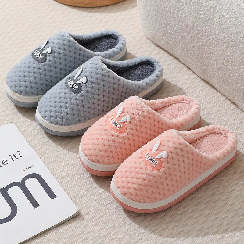 Women's plaid design house slippers with artificial fur upper and thick rubber sole in various colours.