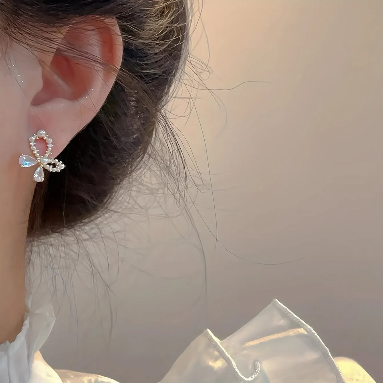 Silver electroplated copper butterfly earrings with geometric accents on a white background