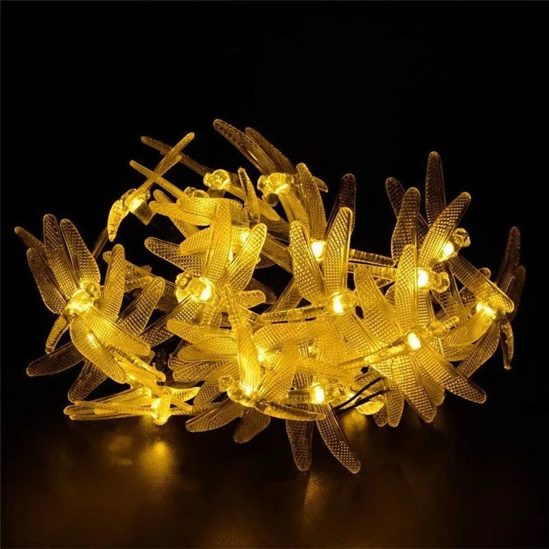 5 metre long solar-powered LED string lights with 30 warm white bulbs, shown with a solar panel on a spike for garden decoration.