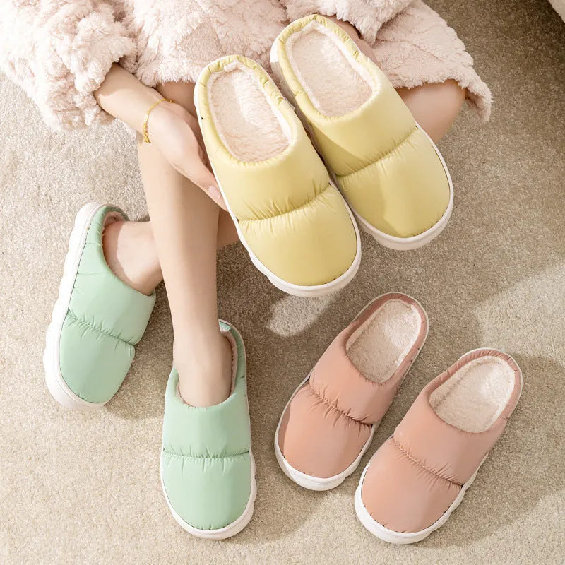 Down cotton house slippers with artificial leather upper, rubber sole, and plush lining in blue colour
