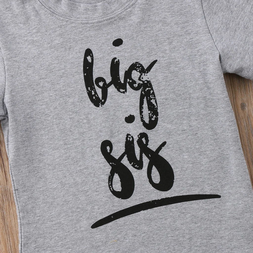 Grey cotton children's t-shirt with printed sibling graphic, showing size range from 60cm to 140cm.