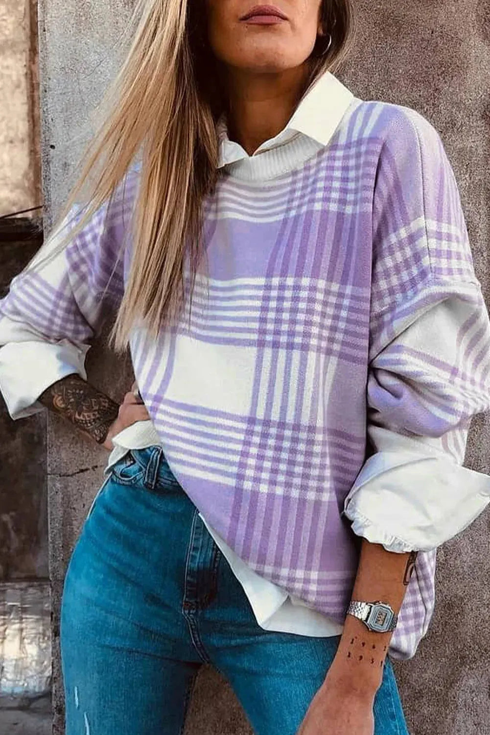 Lilac plaid print loose knit sweater with ribbed cuffs and hem on a hanger.