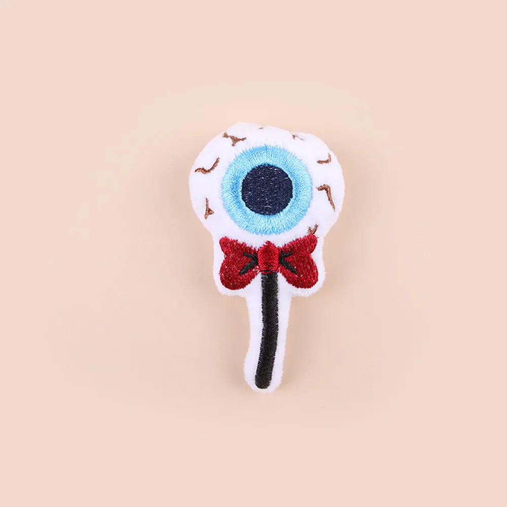 Colourful plush cat teaser wand with candy and eye-shaped attachments for interactive play