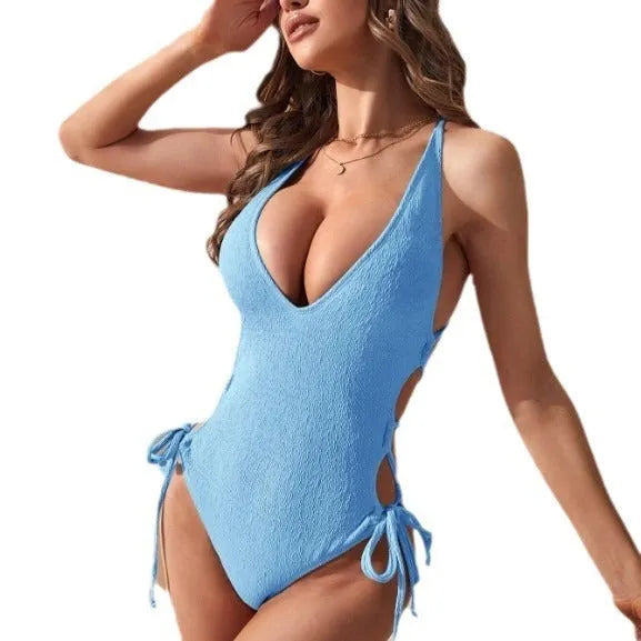 Women's black hollow backless one-piece swimsuit with a tether, made from polyester fabric.
