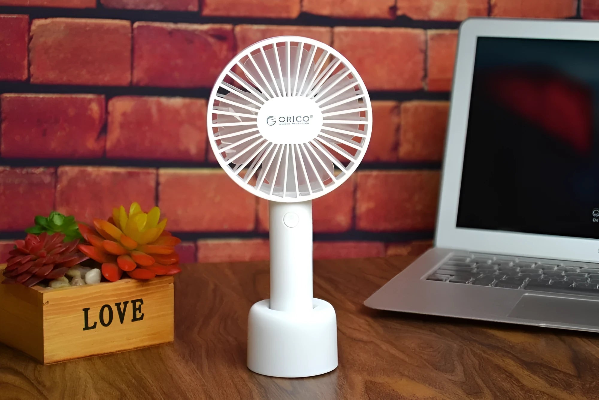 White ORICO FH1 portable USB rechargeable handheld desk fan with three-speed settings.