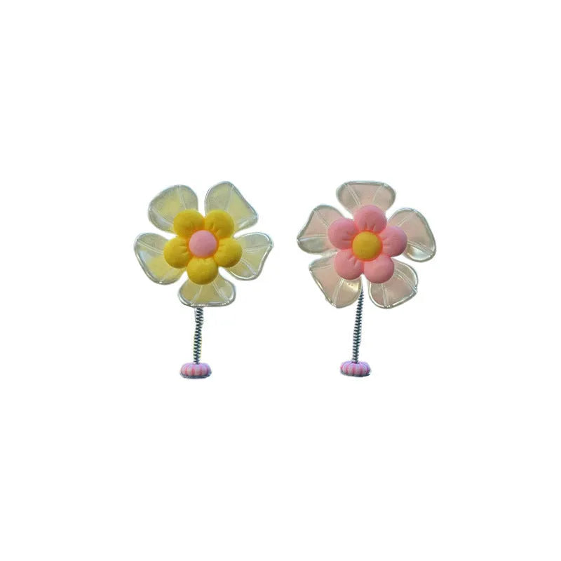 Small plastic colourful swing car decoration shown in multiple colour options.
