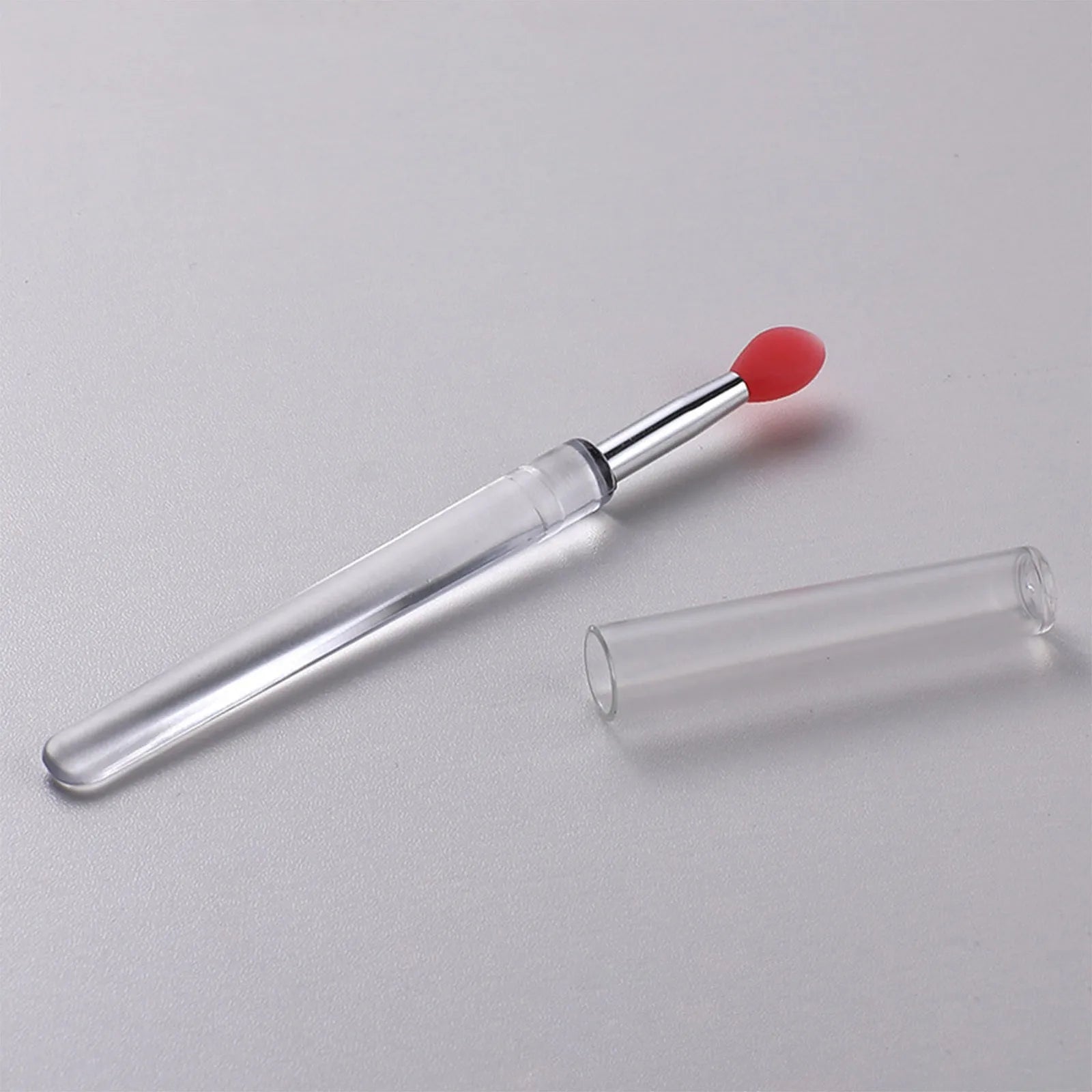 Set of reusable silicone lip brushes with protective caps in various colours for applying lipstick and gloss