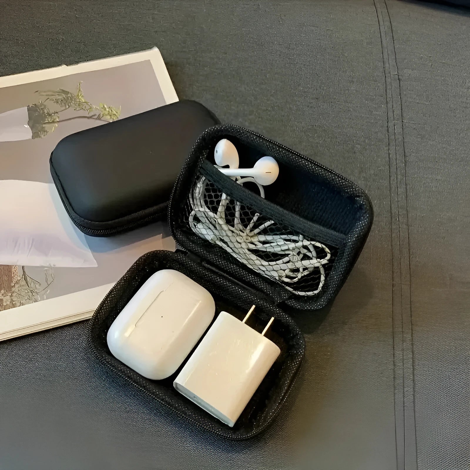 Compact black EVA travel storage box for headset cables, size 11x7.5x4 cm, on a neutral background.
