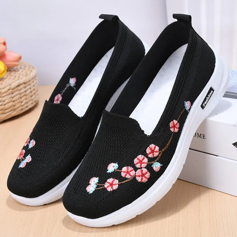 Women's wine red embroidered floral sports pumps with a flat heel and anti-slip sole on a white background.